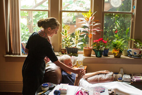 Home health nurse providing wound care